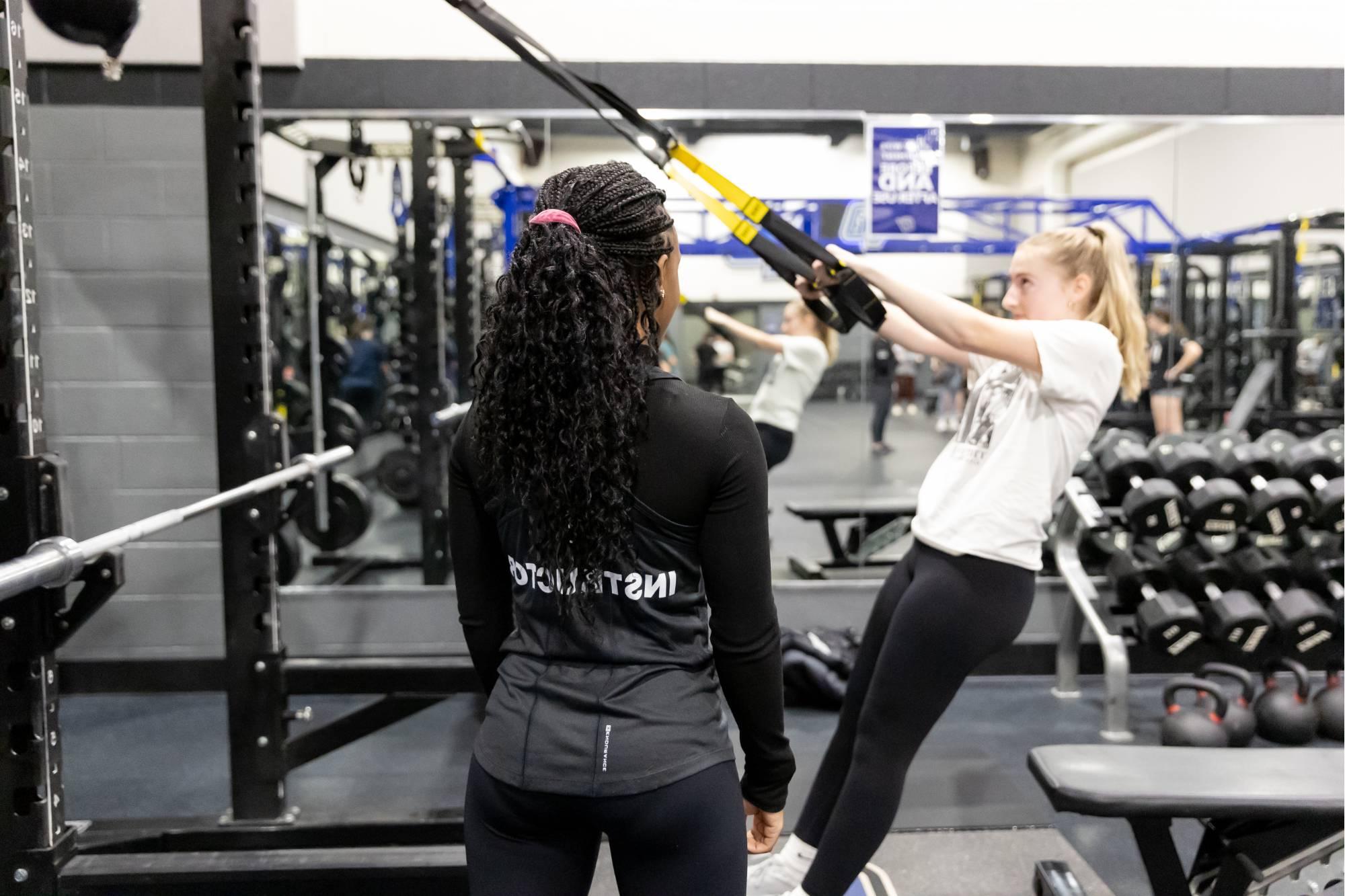 fitness trainer working with a client.